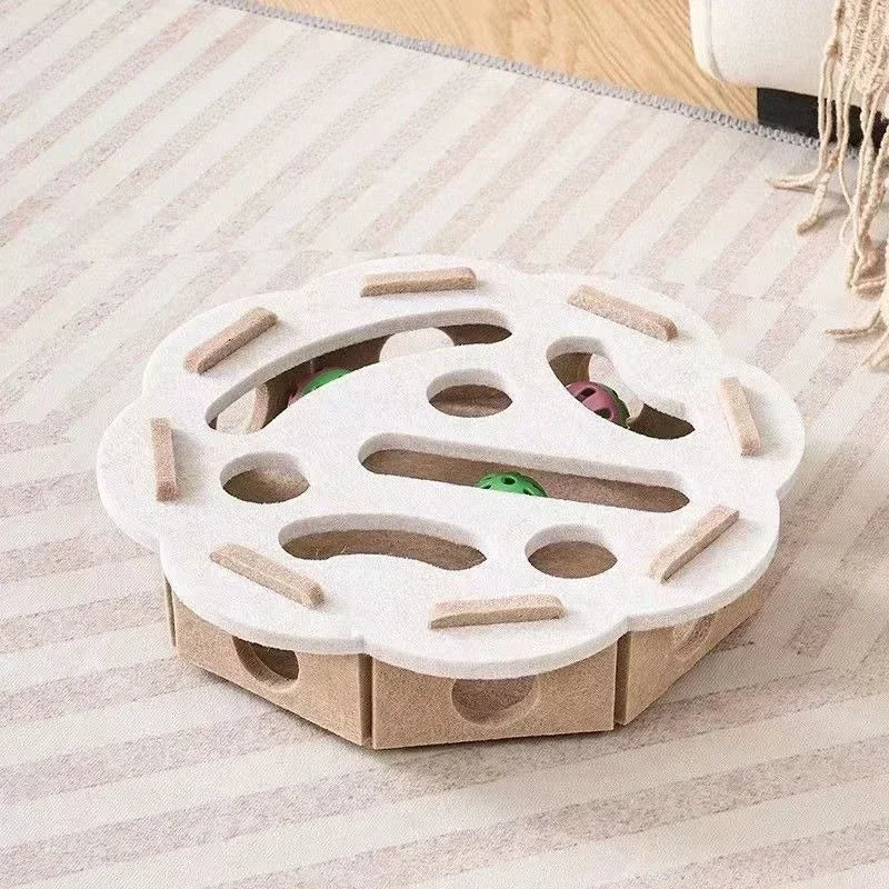 The flower-shaped interactive cat puzzle box in a beige and brown felt material.