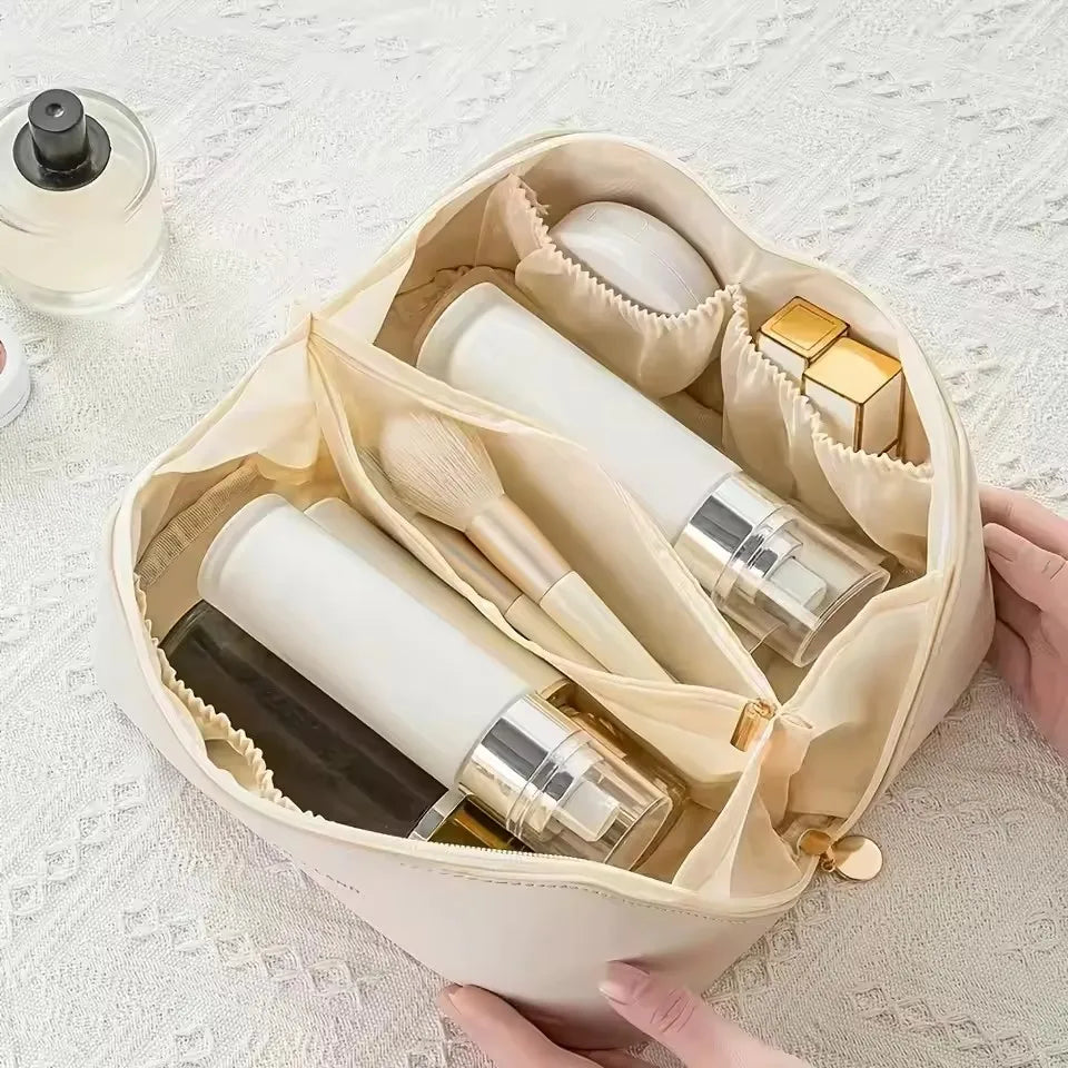 A top-down view of the cream-white LuxeCase makeup bag, showing its organized compartments filled with cosmetics.