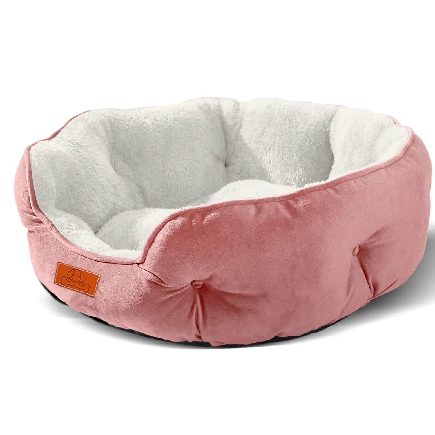 A clean product shot of the round pink version of the pet bed, showing its soft white fleece interior.