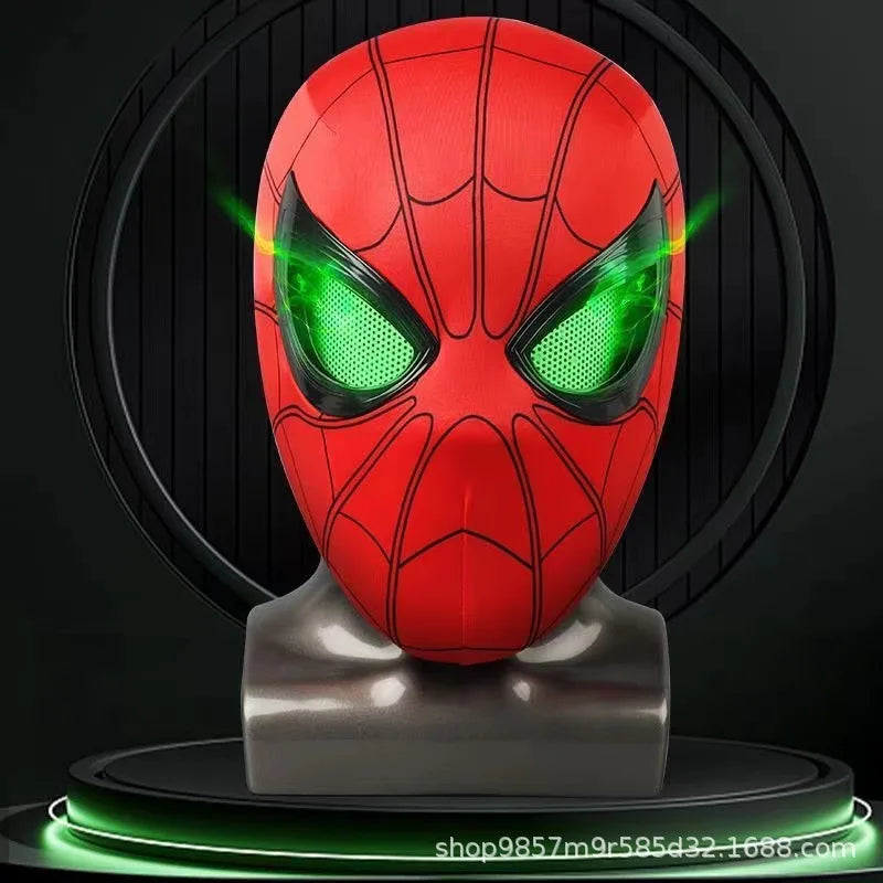 The red Spiderman mask displayed on a mannequin head with its eyes glowing a vibrant green.