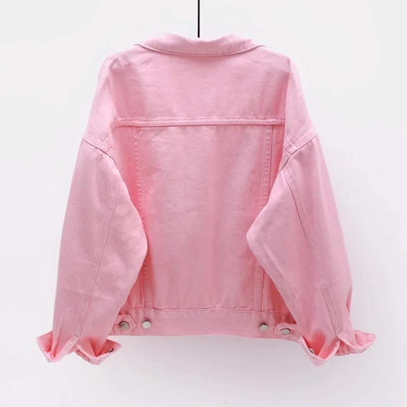 The back view of the women's oversized classic denim jacket in a soft pink color.