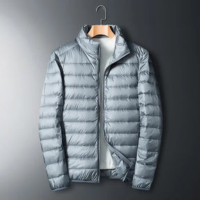 The ArcticWave men's lightweight down jacket shown in a light grey color.