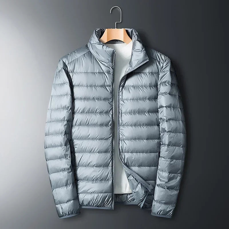 The ArcticWave men's lightweight down jacket shown in a light grey color.