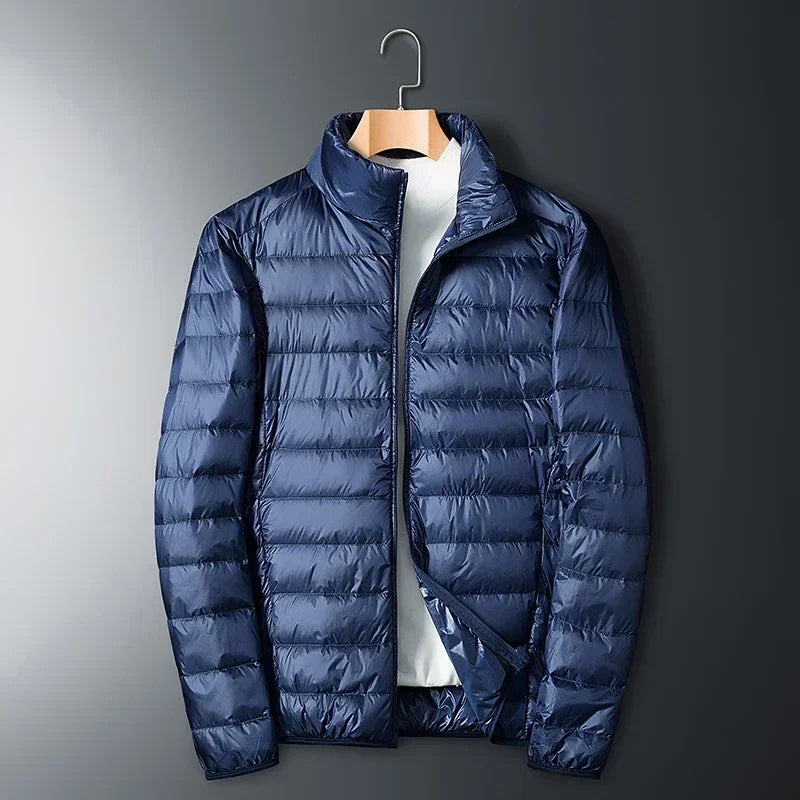 The ArcticWave men's lightweight down jacket shown in a deep navy blue color.