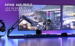 The FIFINE A6T microphone set up on a gaming desk, showing its integration with a dual-monitor setup for streaming or gaming.