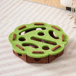 The flower-shaped interactive cat puzzle box in a green and brown felt material.