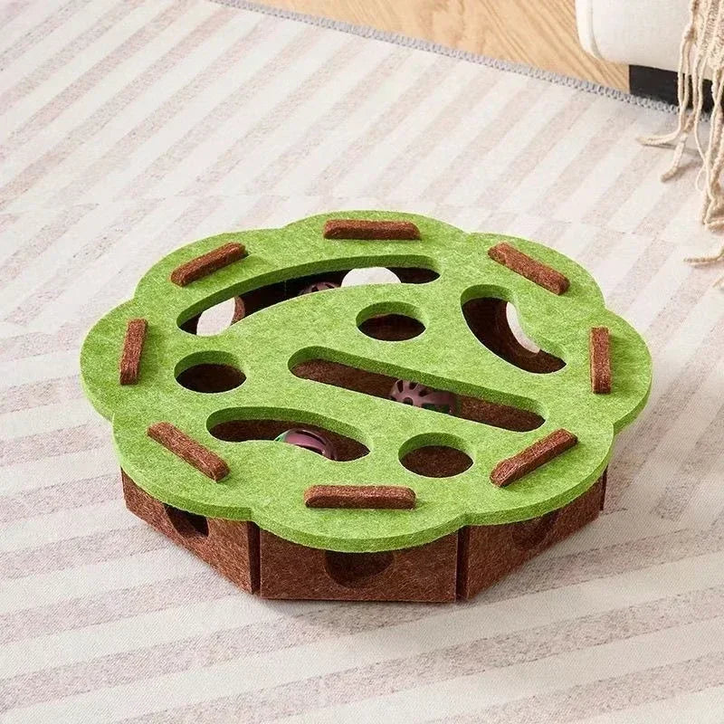 The flower-shaped interactive cat puzzle box in a green and brown felt material.