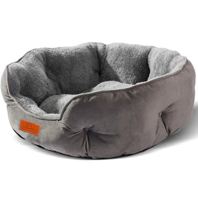 A clean product shot of the round grey pet bed showing its plush corduroy material and soft interior.