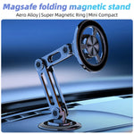 The silver MagSafe folding magnetic stand mounted on a car dashboard, highlighting its aero alloy material and compact design.