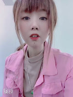 A video of a model showcasing the oversized denim jacket, trying it on in various colors including pink, yellow, white, and purple.
