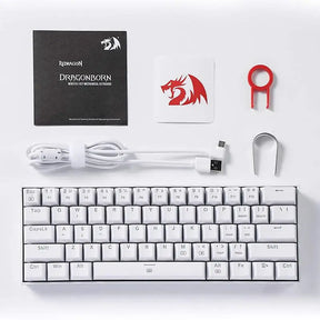 All items included with the Redragon K630 Dragonborn keyboard: the keyboard itself, instruction manual, sticker, detachable USB-C cable, and keycap puller.