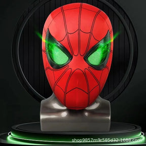 The red Spiderman mask displayed on a mannequin head with its eyes glowing a vibrant green.