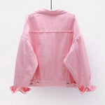 The back view of the women's oversized classic denim jacket in a soft pink color.