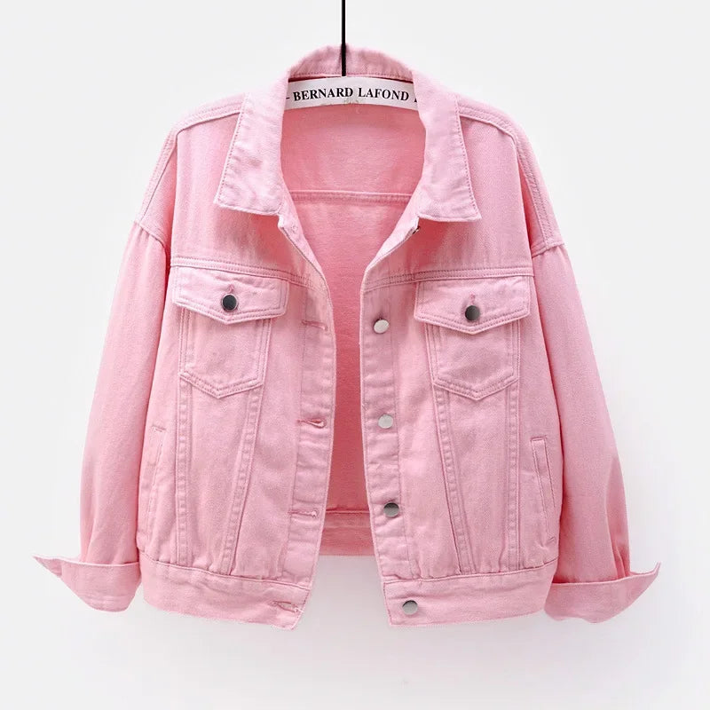 The women's oversized classic denim jacket in a soft pink color, shown from the front.