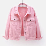 The women's oversized classic denim jacket in a soft pink color, shown from the front.