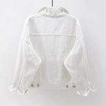 The back view of the women's oversized classic denim jacket in a crisp white color.